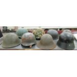 Seven various military and other helmets: to include World War II German type (Please Note: this