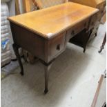 A 1920s light oak three drawer kneehole desk,