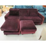 A modern purple fabric upholstered two seater settee with a cushioned back,