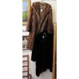 A black fur coat with large buttons approx.