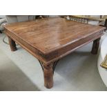 A modern Indonesian teak coffee table, raised on turned legs and wrought iron bracket supports 15.