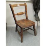 A child's 20thC stained beech country made style bar back chair,