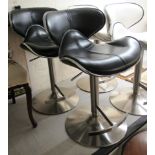 A pair of modern black hide upholstered breakfast stools,