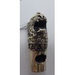 A silver lion's head whistle stamped Sterling 11