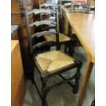 A set of six mid 20thC stained oak ladderback dining chairs with woven rush seats,