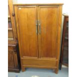 A 20thC Chinese fruitwood cupboard,
