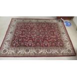 A Persian rug, profusely decorated with flora and foliage,