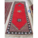A Persian runner with opposing tasselled ends and three central starburst motifs,