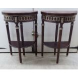 A pair of Empire style mahogany and figured walnut finished pedestal design,