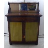 A Regency rosewood chiffonier with a mirror panelled upstand, half shelf and a brass gallery,