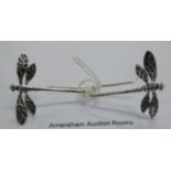 A pair of silver coloured metal dragonfly earrings 11