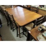 A Mcintosh teak extending dining table, the top incorporating folding leaves, raised on turned,