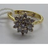 An 18ct gold diamond cluster ring 11