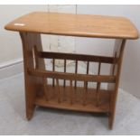 An Ercol pale beech and elm occasional table/stool with a magazine rack underframe,