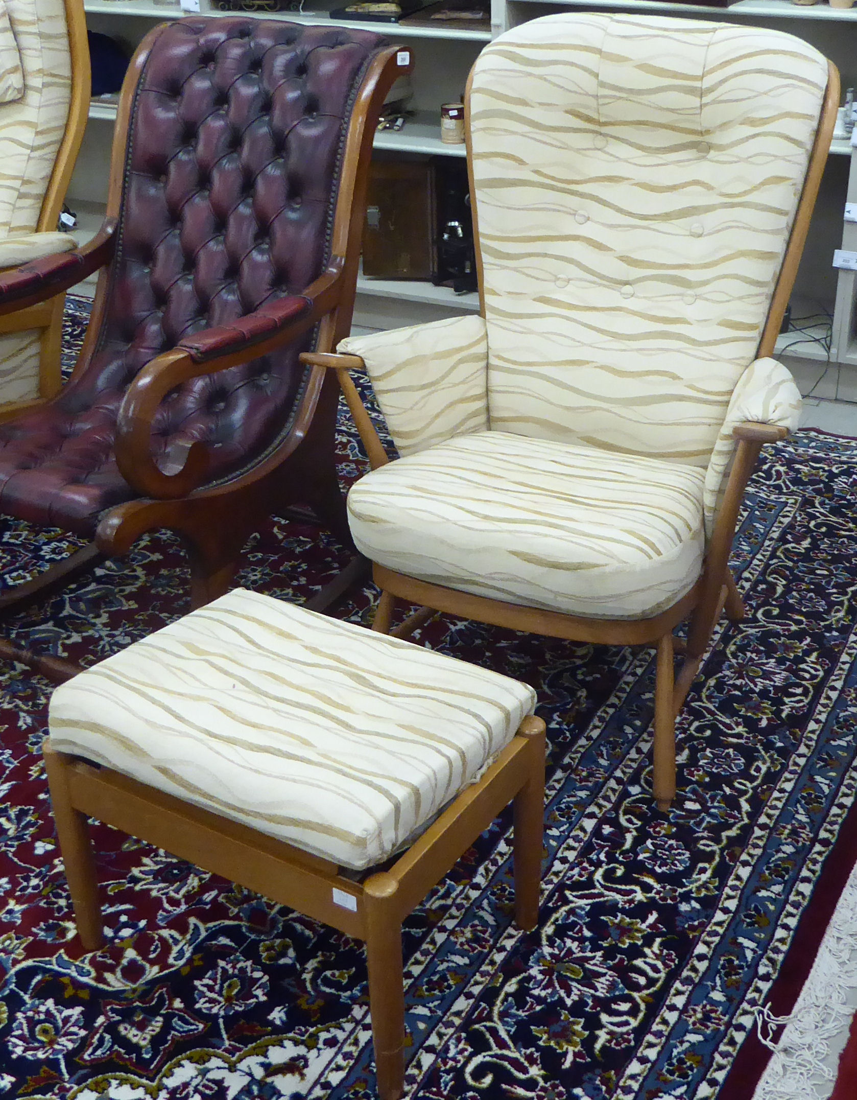 An Ercol beech framed high hoop and spindled back, enclosed arm chair,