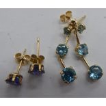 A pair of 9ct gold claw set, blue topaz drop earrings; and a pair of 9ct gold studs,