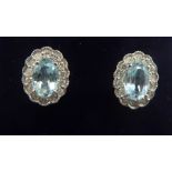 A pair of 18ct white gold aquamarine and diamond set oval earrings 11