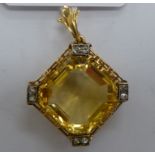 A gold coloured metal open framed pendant of square design,