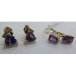 A pair of gold coloured metal claw set amethyst earrings;