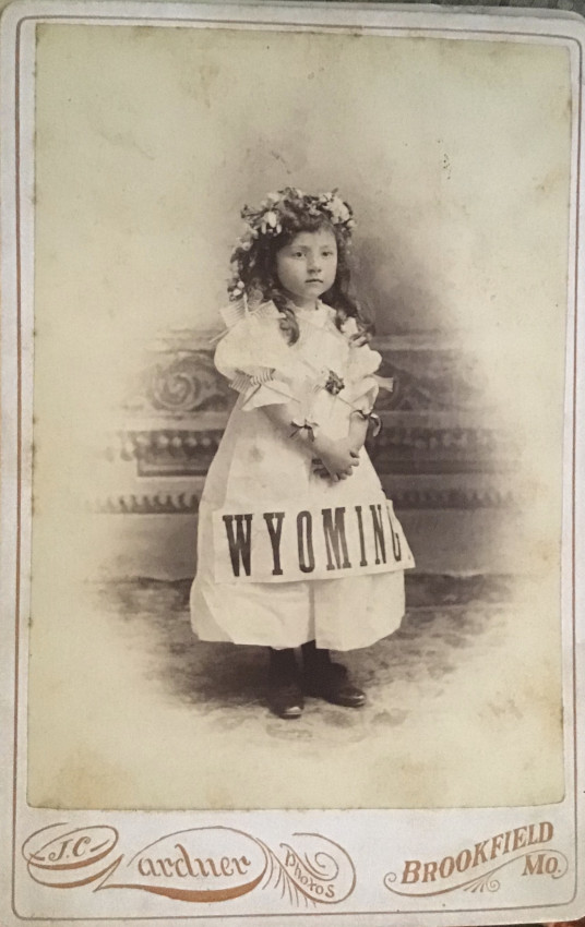 J. C. GARDNER [PHOTOGRAPHER] WYOMING, young girl posing with a banner on dress together with 4