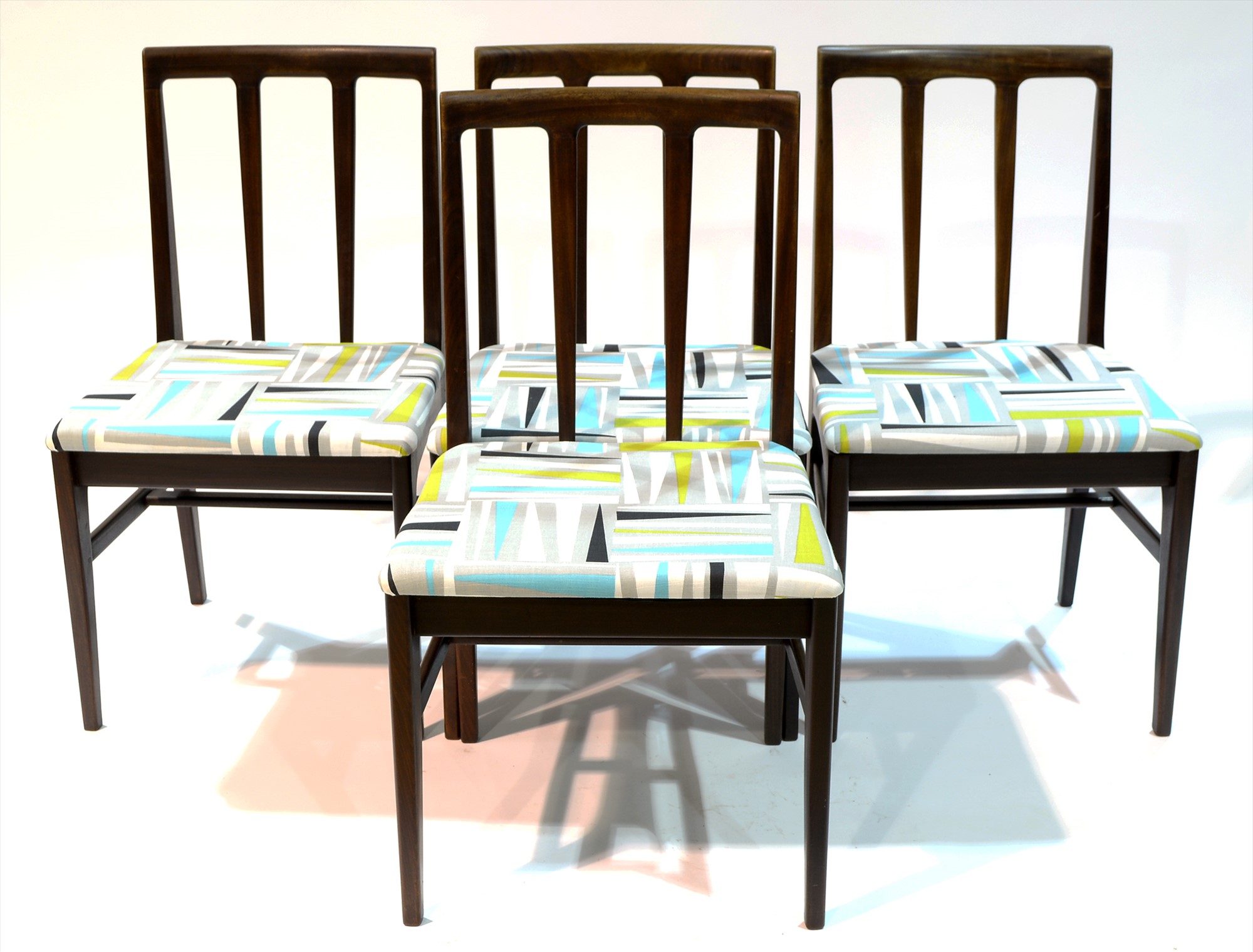 Four Afromosia dining chairs.