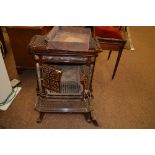 An early 20th Century cast iron brown enamelled stove, possibly Continental, complete with ash tray,