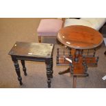 A circular walnut occasional table with X-shaped undertier and spindle gallery, raised on three