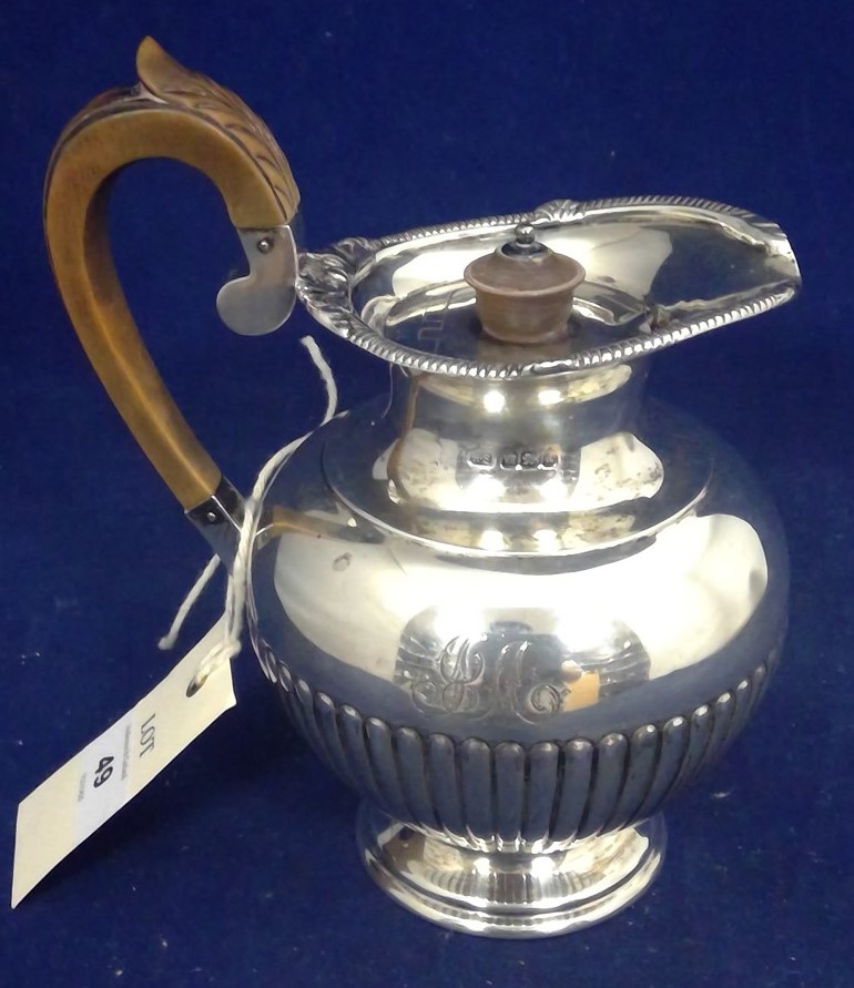 A silver water jug