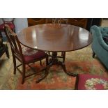 An early 20th century tilt-top supper table, the circular top above a central baluster turned