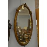 An early 20th century oval gilt and gesso mirror