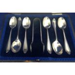 Silver teaspoons and sugar tongs