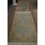 A 20th century Chinese style rug together with another