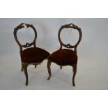 Two Victorian balloon back dining chairs, the shaped backs above seats covered in red dralon.