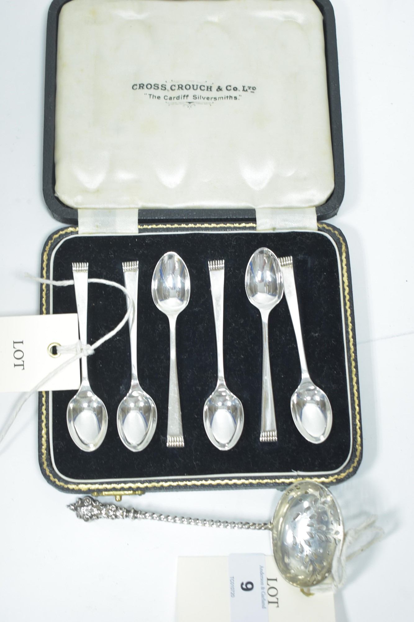 Silver teaspoons and sugar sifter