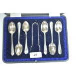 Silver teaspoons and tongs