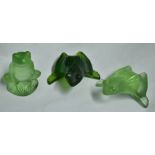 Three Lalique models of frogs.