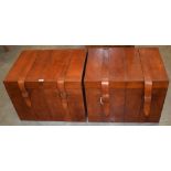 A pair of modern tan leather reproduction travel trunks, of broad rectangular outline, with