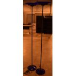 A pair of blue glass and lacquered black metal uplighters, with oval shades and conical bases,