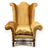 A Queen Anne style wing-back armchair