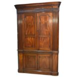 A large George III mahogany corner cabinet