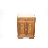 A French 20th Century side cabinet with inset cream marble top, above a single frieze drawer and