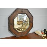 A 1920's carved and beaded oak octagonal mirror, 62 cms, A rectangular mirror constructed with