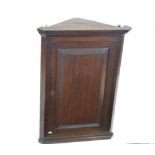 Late George III oak corner cabinet