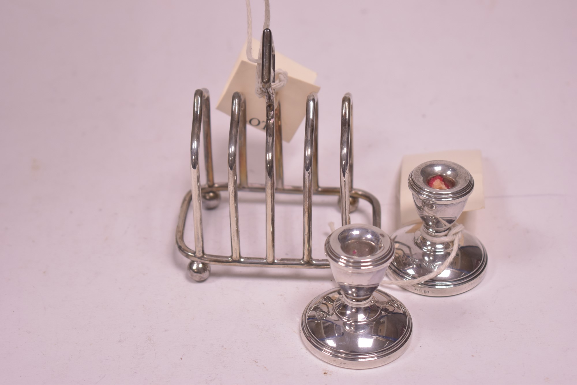 Silver toast rack and pair of miniature candlesticks