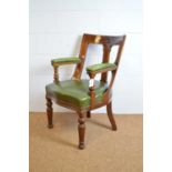 A Victorian walnut buckle back armchair.