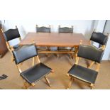 A reproduction gothic style oak dining table and six dining chairs