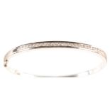 A diamond set 18ct white gold bangle