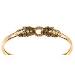 A leopard pattern yellow metal bangle