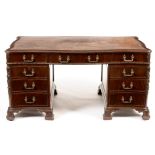George III style mahogany serpentine pedestal desk