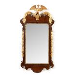 A reproduction George II style mahogany and giltwood wall mirror